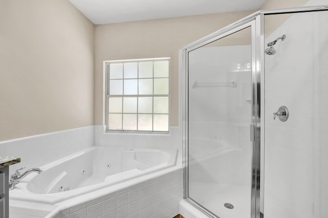 bathroom featuring separate shower and tub