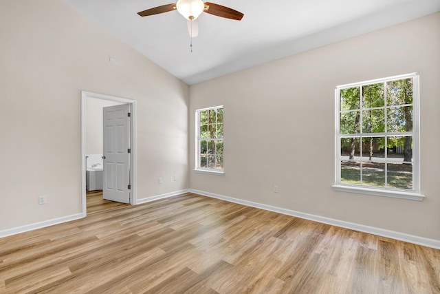 spare room featuring ceiling fan, lofted ceiling, and light hardwood / wood-style floors