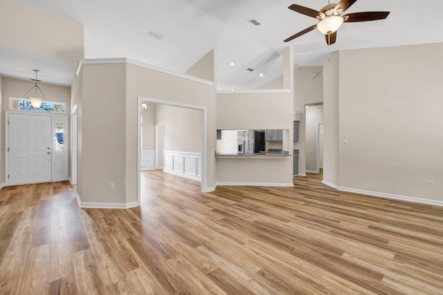 unfurnished living room featuring ceiling fan, high vaulted ceiling, and light wood-type flooring