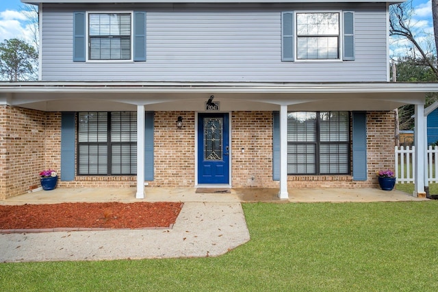 property entrance with a lawn