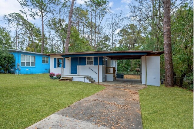 2069 Holmes St, Tallahassee, FL 32305 - ranch-style home featuring driveway, an attached carport, and a front lawn