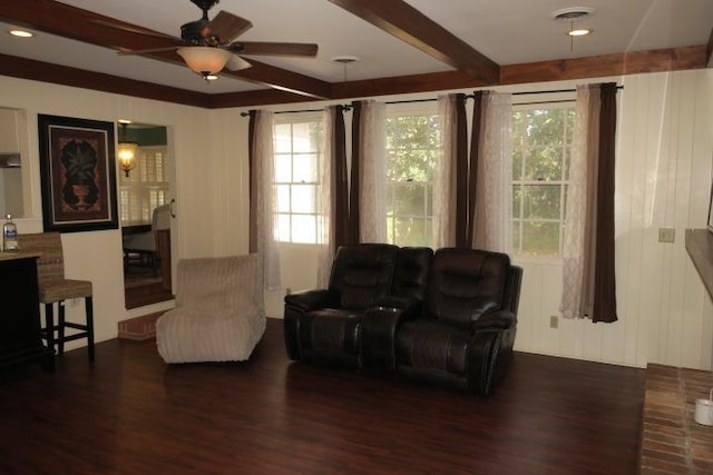 sitting room featuring ceiling fan, beamed ceiling, and dark hardwood / wood-style floors