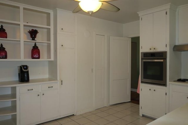 kitchen with white cabinetry, stainless steel oven, ceiling fan, light tile patterned floors, and gas cooktop