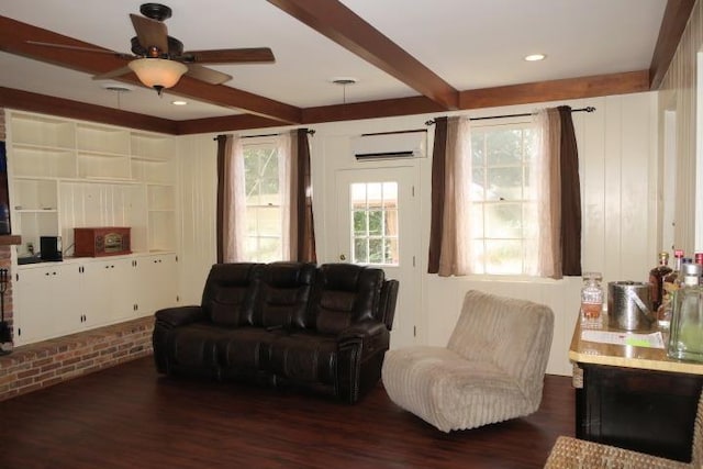 living room featuring built in shelves, ceiling fan, a wall mounted air conditioner, dark hardwood / wood-style flooring, and beamed ceiling