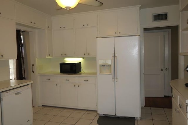 kitchen featuring white appliances, white cabinetry, crown molding, and light tile patterned flooring