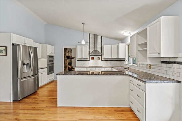 2521 Harriman Cir, Tallahassee, FL 32308 - kitchen with appliances with stainless steel finishes, lofted ceiling, backsplash, white cabinets, and dark stone countertops