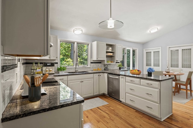 2521 Harriman Cir, Tallahassee, FL 32308 - kitchen with dishwasher, a peninsula, decorative backsplash, open shelves, and vaulted ceiling