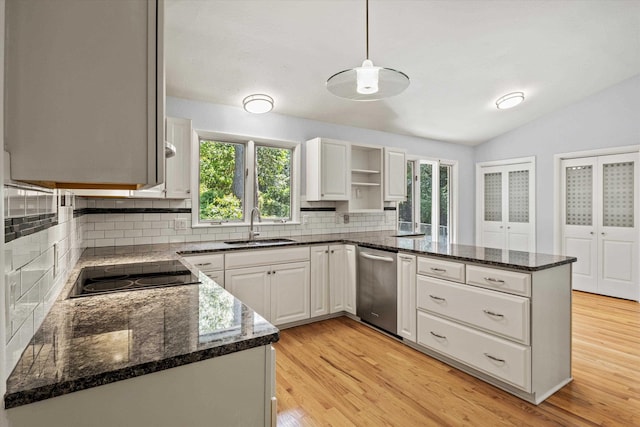 2521 Harriman Cir, Tallahassee, FL 32308 - kitchen with a peninsula, dishwasher, backsplash, light wood-style floors, and vaulted ceiling