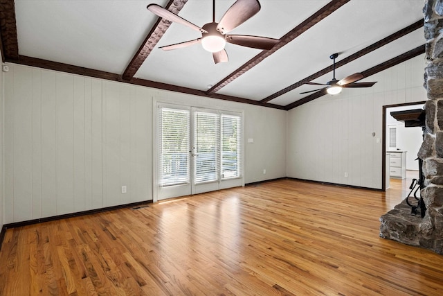 2521 Harriman Cir, Tallahassee, FL 32308 - unfurnished living room featuring a ceiling fan, light wood-style floors, wooden walls, and a fireplace