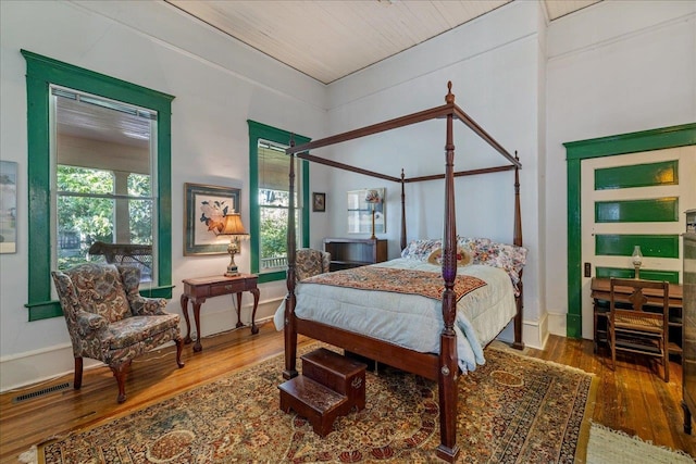 bedroom featuring wood ceiling and hardwood / wood-style flooring