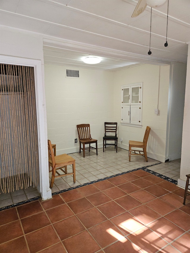 living area with tile patterned floors