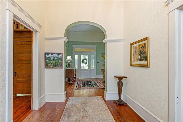 727 Miccosukee Rd, Tallahassee, FL 32308 - entrance foyer with arched walkways, wood-type flooring, and baseboards