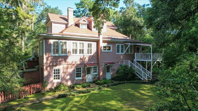 727 Miccosukee Rd, Tallahassee, FL 32308 - back of house with stairway, a chimney, cooling unit, roof with shingles, and a wooden deck