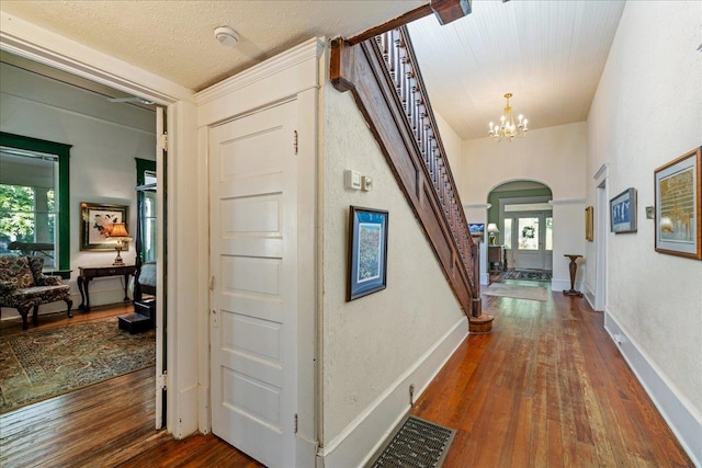 hallway with plenty of natural light and dark wood-type flooring