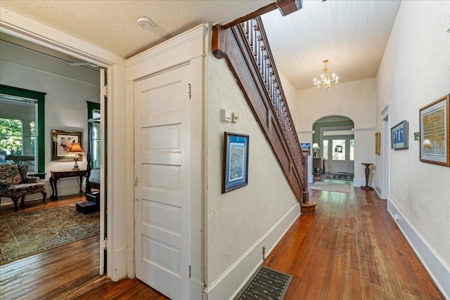 727 Miccosukee Rd, Tallahassee, FL 32308 - hallway with arched walkways, stairs, dark wood-style floors, and healthy amount of natural light