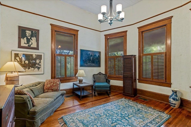 living area featuring wood-type flooring and a notable chandelier