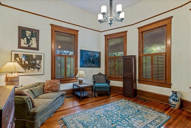 727 Miccosukee Rd, Tallahassee, FL 32308 - living area featuring a chandelier, wood-type flooring, healthy amount of natural light, and baseboards