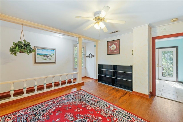 interior space featuring ornamental molding, hardwood / wood-style floors, and ceiling fan