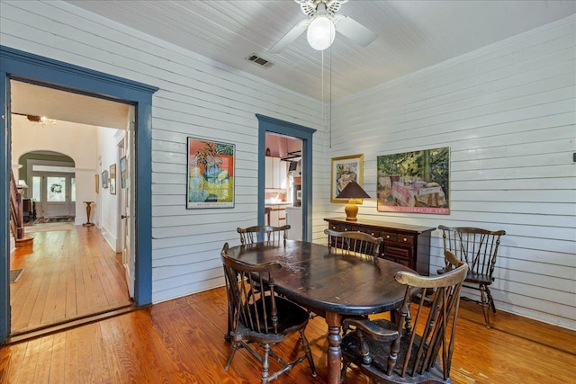 727 Miccosukee Rd, Tallahassee, FL 32308 - dining area with wood walls, arched walkways, hardwood / wood-style flooring, and a ceiling fan
