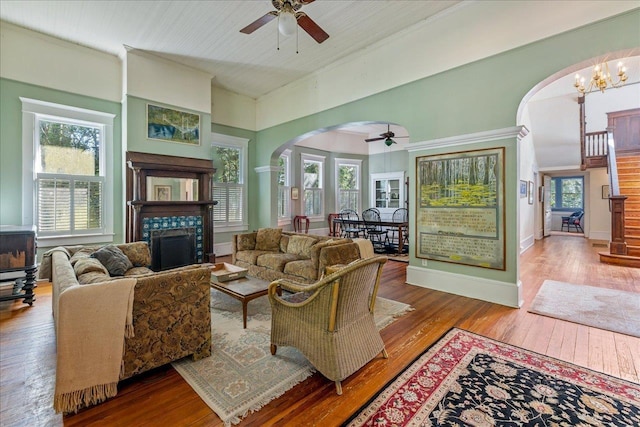 727 Miccosukee Rd, Tallahassee, FL 32308 - living area with arched walkways, ceiling fan, a tile fireplace, and wood-type flooring