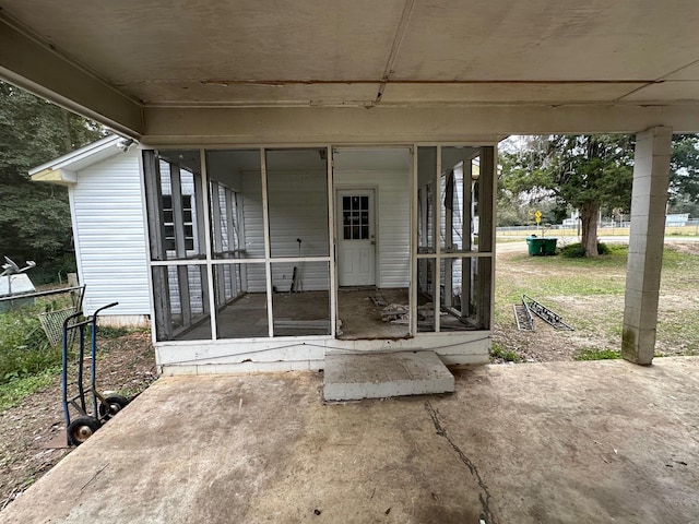 view of patio featuring a sunroom