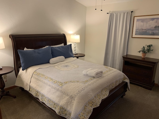 bedroom with dark colored carpet