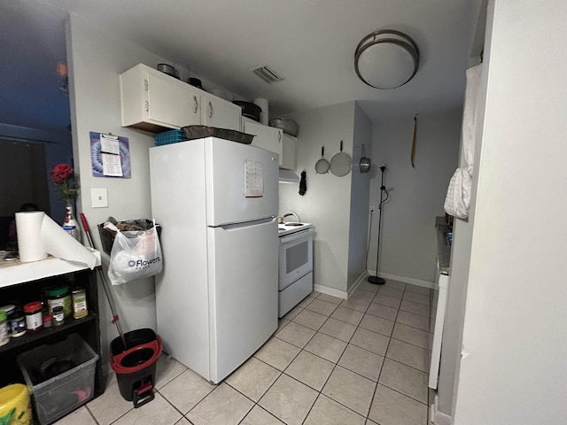1518 Mabry St, Tallahassee, FL 32310 - kitchen featuring visible vents, light tile patterned floors, under cabinet range hood, white appliances, and white cabinetry