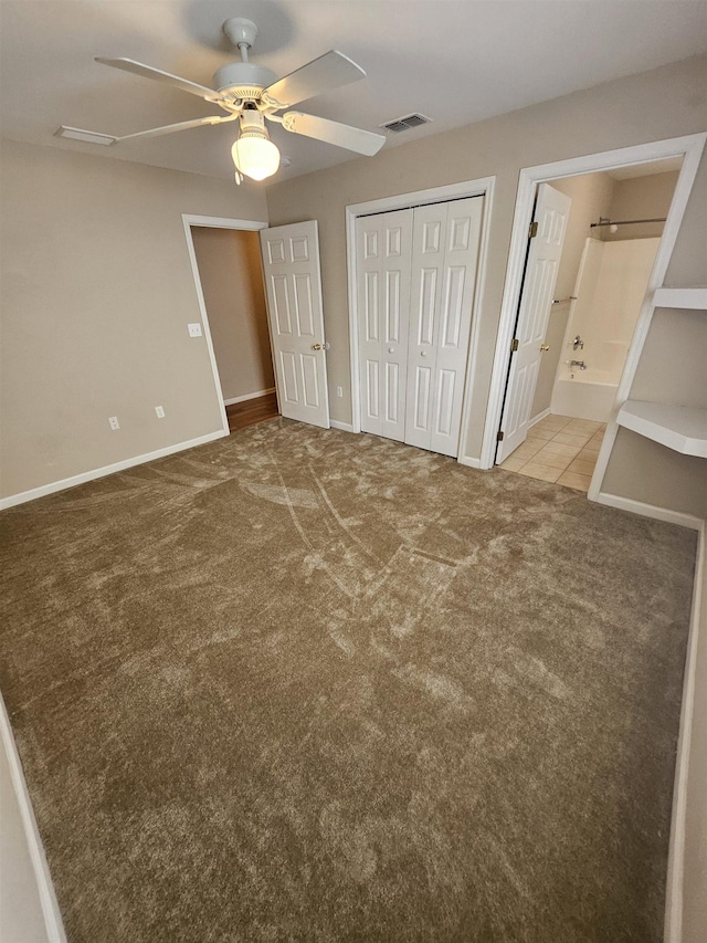 unfurnished bedroom with ceiling fan, light colored carpet, connected bathroom, and a closet