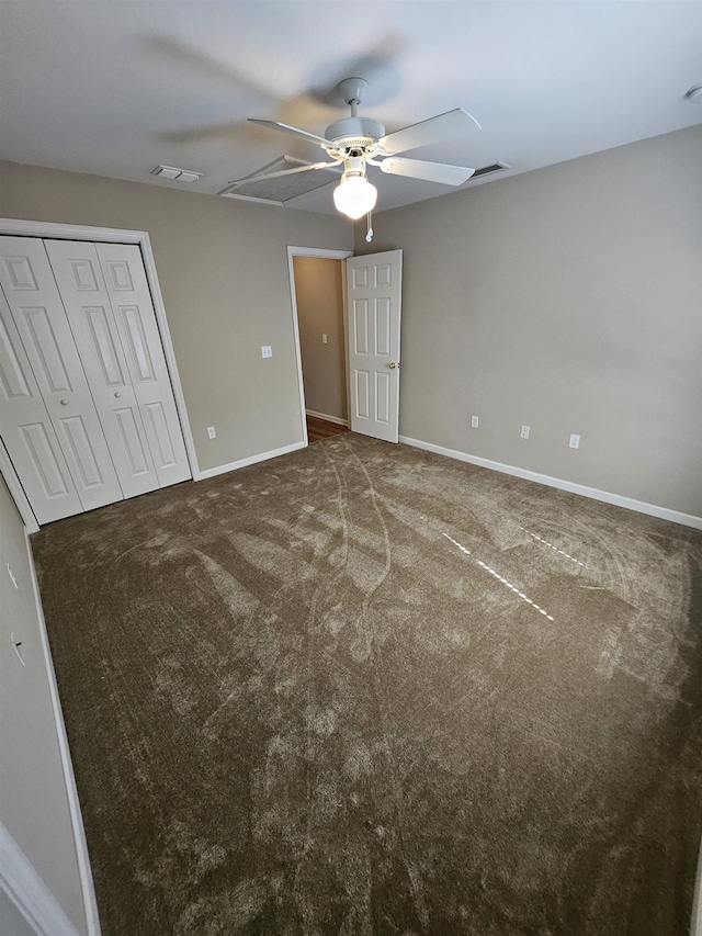 unfurnished bedroom with carpet, ceiling fan, and a closet