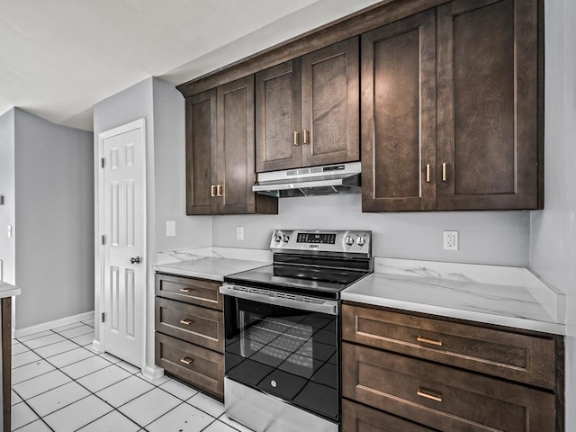 kitchen featuring light stone counters, light tile patterned floors, electric range, and dark brown cabinets