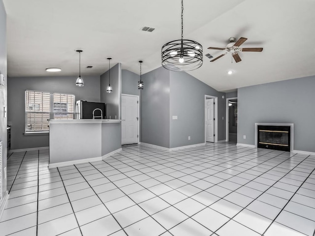 unfurnished living room featuring lofted ceiling, light tile patterned floors, and ceiling fan