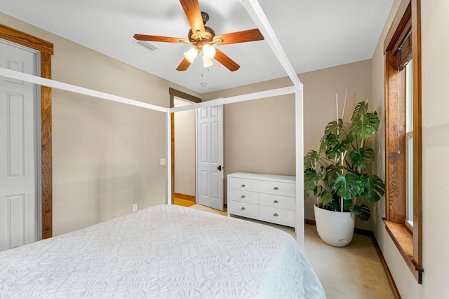 bedroom featuring light carpet, ceiling fan, and visible vents