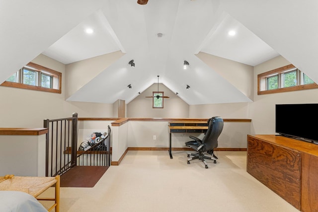 office with a healthy amount of sunlight, baseboards, vaulted ceiling, and light colored carpet