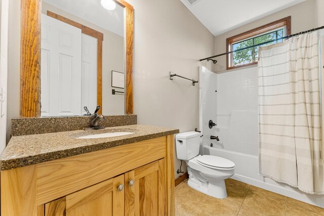 full bathroom featuring toilet, shower / tub combo with curtain, tile patterned floors, vaulted ceiling, and vanity