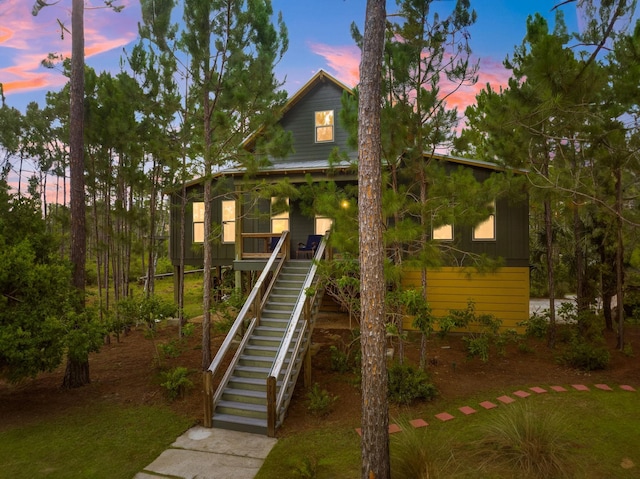 view of front of property featuring stairway