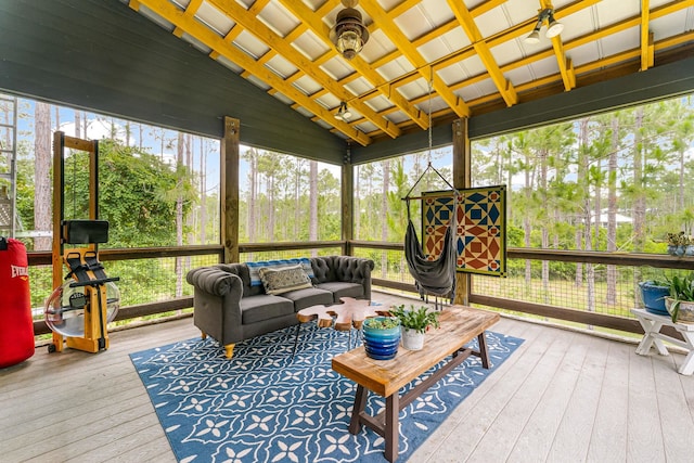 sunroom with a wealth of natural light, lofted ceiling, and ceiling fan