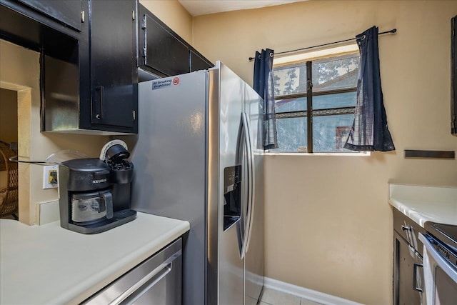 kitchen with stainless steel appliances and light tile patterned floors