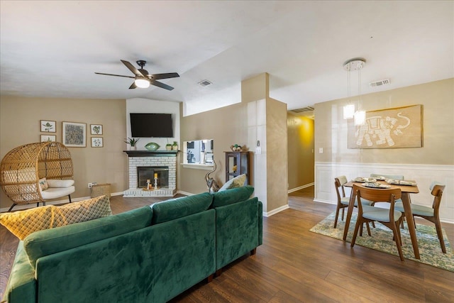 living room with ceiling fan, lofted ceiling, dark hardwood / wood-style floors, and a fireplace