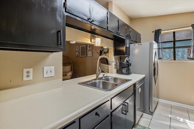 kitchen featuring light tile patterned floors, sink, and appliances with stainless steel finishes