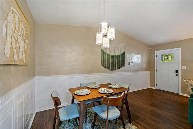 dining room with dark hardwood / wood-style flooring and a notable chandelier