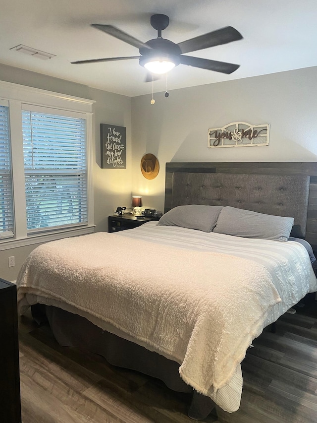 bedroom with ceiling fan and hardwood / wood-style floors