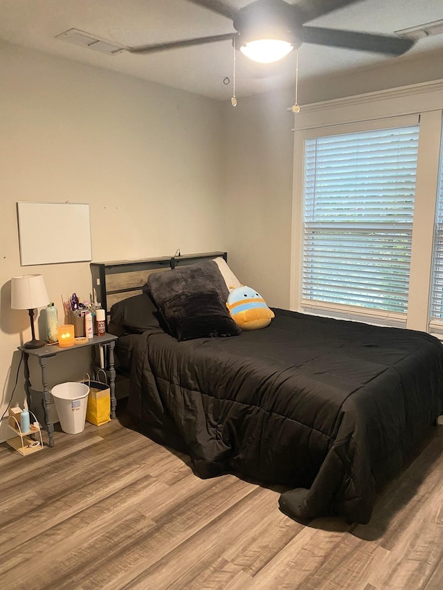 bedroom featuring ceiling fan and hardwood / wood-style flooring