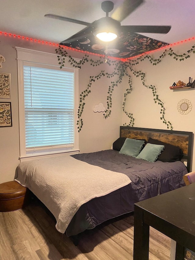 bedroom featuring ceiling fan and wood-type flooring