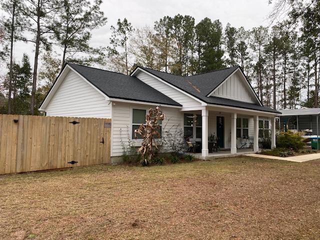 view of front of house featuring a front yard and a porch