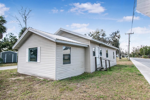 view of home's exterior with a yard