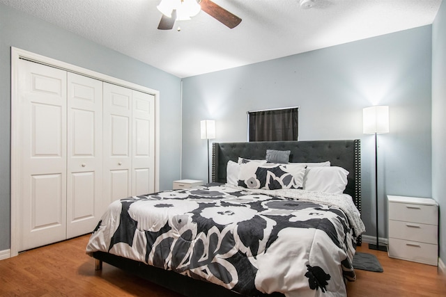 bedroom featuring ceiling fan, light hardwood / wood-style floors, and a closet