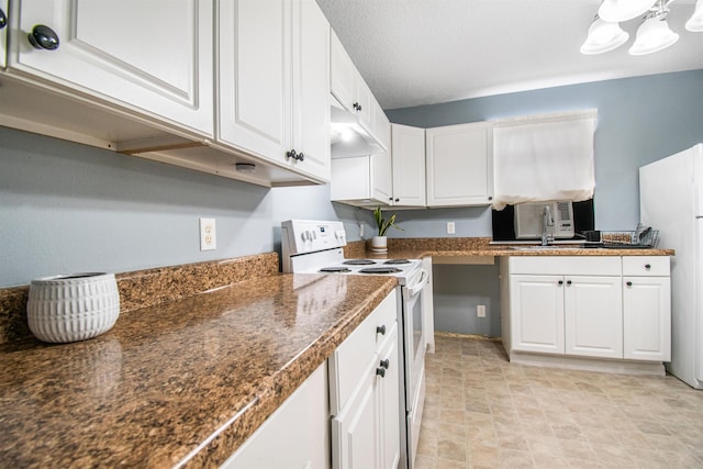 kitchen with white cabinetry, white appliances, dark stone counters, and a textured ceiling