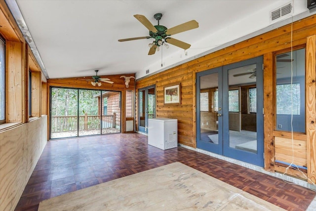 unfurnished sunroom with lofted ceiling and french doors