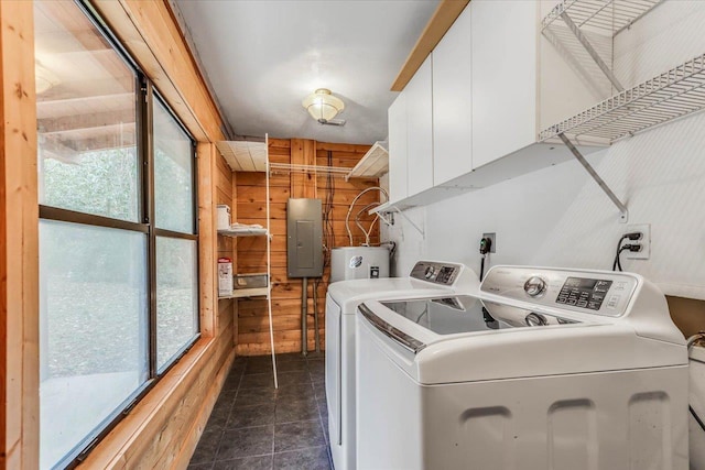 clothes washing area featuring electric panel, separate washer and dryer, water heater, and plenty of natural light