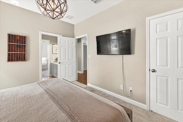 3256 Whitman Way, Tallahassee, FL 32311 - bedroom featuring a chandelier, carpet, and connected bathroom